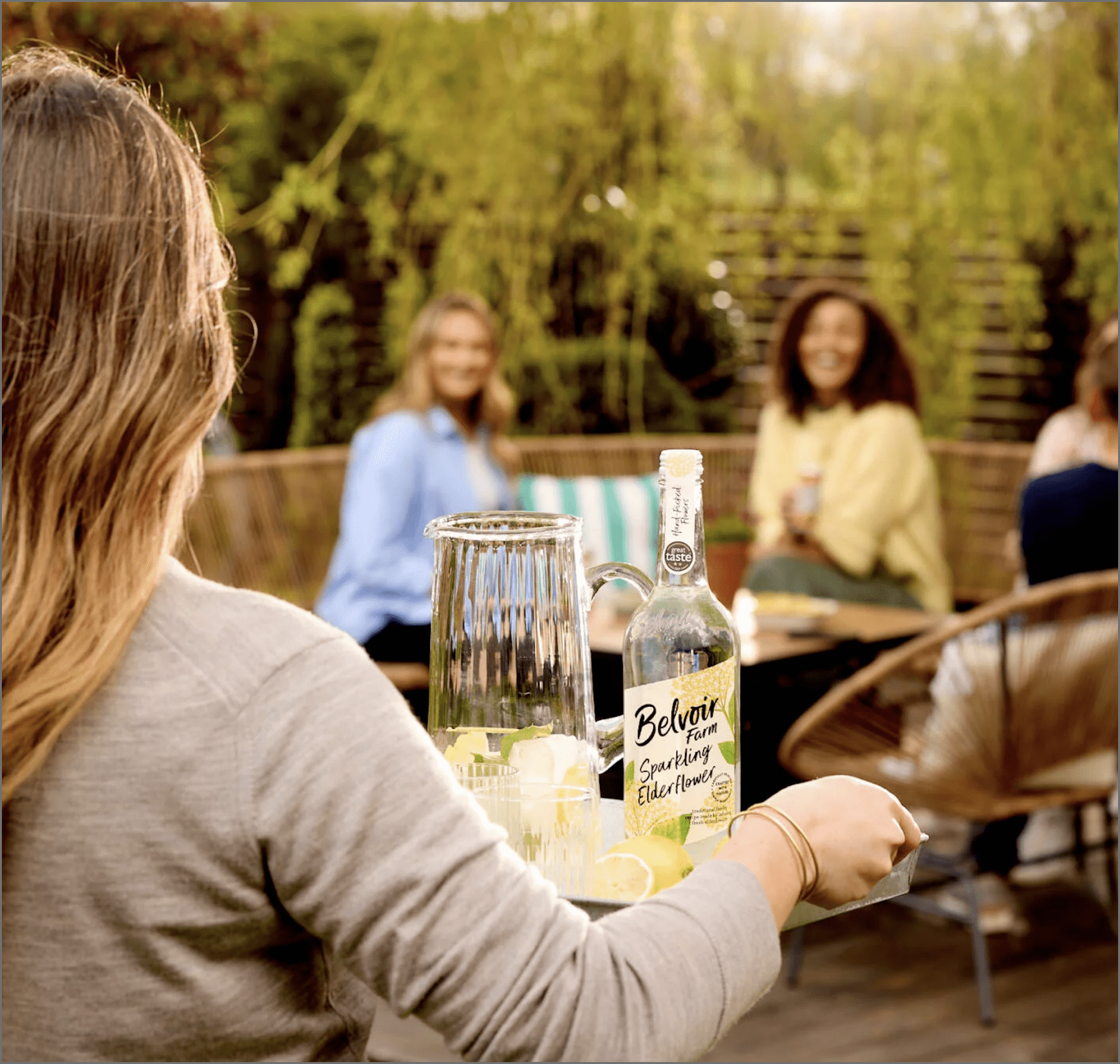 A woman carrying a tray of drinks