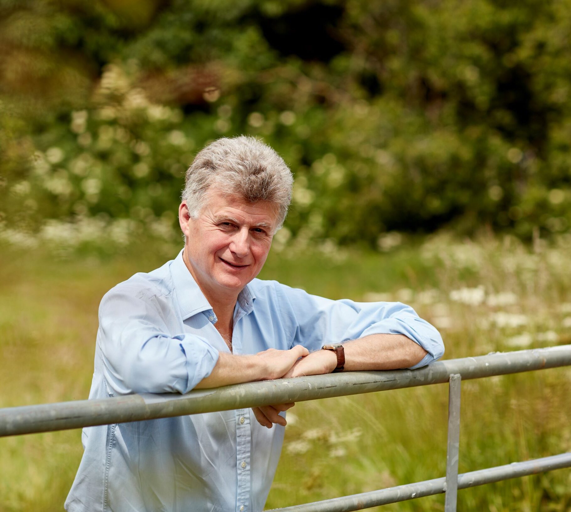 peveral manners, owner of Belvoir Farm, leaning on a gate in a feild